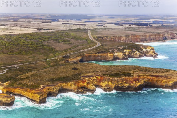 Great Ocean Road and the Twelve Apostles is a group of limestone cliffs. Scenic coastline. Picture taken from a helicopter. Port Campbell Park, Australia. The concept of extreme, active and photo tourism