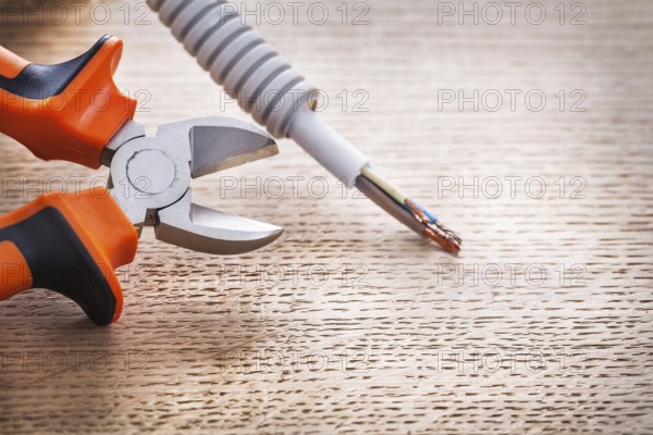 Opened mippers with cable on wooden board construction concept