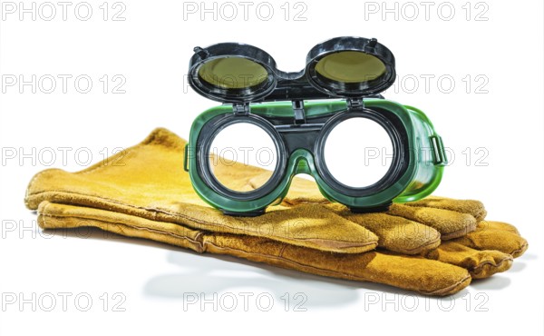 Welder working goggles on pair of gloves isolated