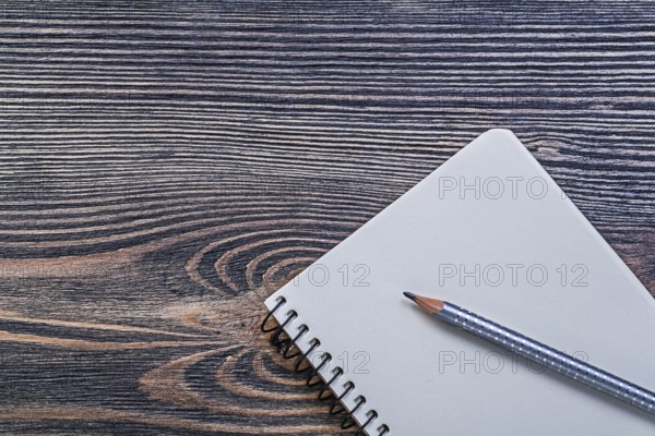 Open copybook pencil on vintage wood board education concept