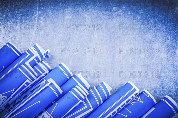 Blue construction drawings on metallic background top view maintenance concept