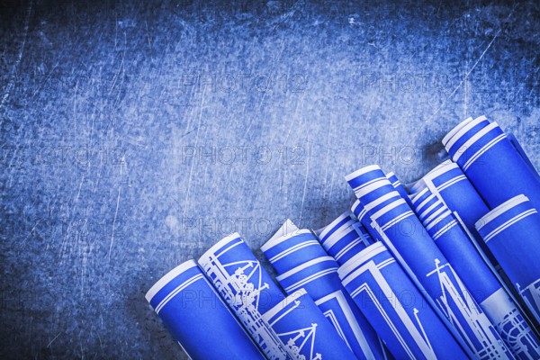 Blue blueprints on metallic background construction concept