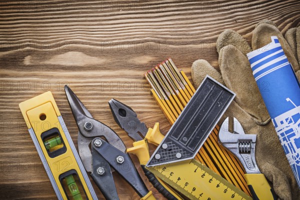 Heap of construction tooling on vintage wooden board