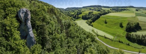 La Fille de Mai, limestone rock rising out of the forest in the Jura, drone shot, Lucelle, Jura, Switzerland
