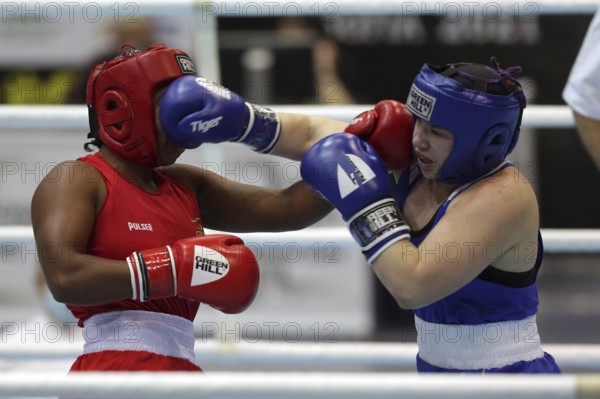Sofia, Bulgaria - 26 February, 2021: Possantos Perejra (red) of Brazil and Nadezhda Ryabets of Kazakhstan fight in their semifinal round of Middle (W75kg) category of the 72-nd International Boxing Tournament Strandja 2021, Sofia, Bulgaria