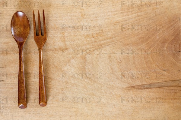 Wooden spoon and fork on a wooden background