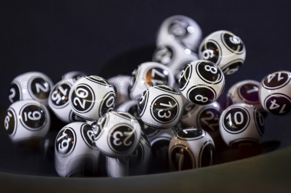 Black and white lottery balls in a bingo machine. Lottery balls in a sphere in motion. Gambling machine and euqipment. Number 13