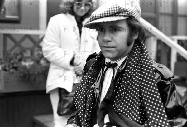 Elton John. English singer, songwriter born march 25 1947. Pictured wearing a chequered cap and a matching chequered scarf during a visit to Sweden 1978