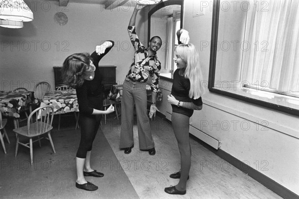 The pop group ABBA. Its two female members Anni-Frid Lyngstad and Agnetha Fältskog practice and train in preparation for the upcoming folk park tour in 1975. Choreographer Graham Tainton leads the exercises. He was a choreographer for Abba. 1975