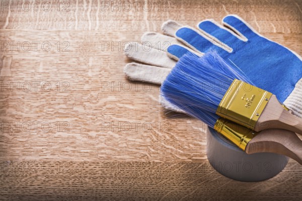 Paint brushes on duct tape and protective gloves construction concept