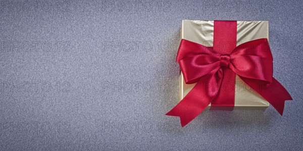 Wrapped box with presents on grey background holidays concept