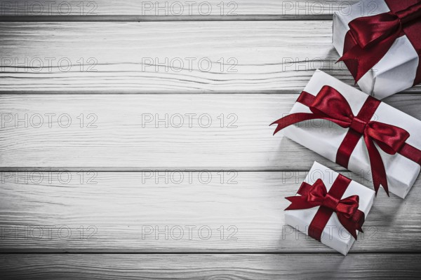 White present boxes on wooden board copyspace holidays concept