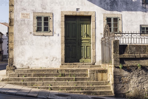 Santiago de Compostela, Spain, July 18, 2020: Old house with green wooden door in medieval town