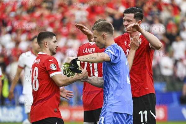 BERLIN, GERMANY - JUNE 21, 2024: Euro 2024 Groupe D match Poland vs Austria 1:3. Team of Austria Romano Schmid (L) Patrick Pentz (M) Michael Gregoritsch (R) joy after win the match.