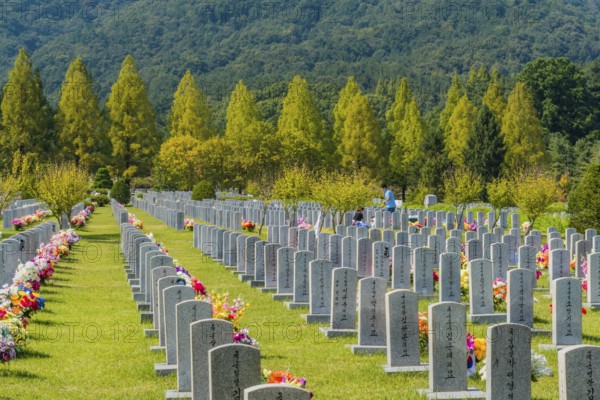 Daejeon, South Korea, September 29, 2019: Family gathered at grave of loved one to pay respect at National cemetery