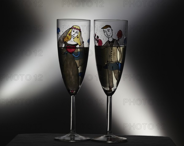 Vintage wedding champagne glasses on black background with crossing lights