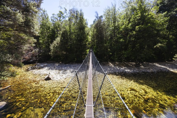 Frenchmans Cap Suspended Bridge in Franklin-Gordon Wild Rivers National Park on a hot summer's day in Tasmania, Australia