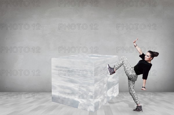 Business woman pushing big ice cube in the gray room