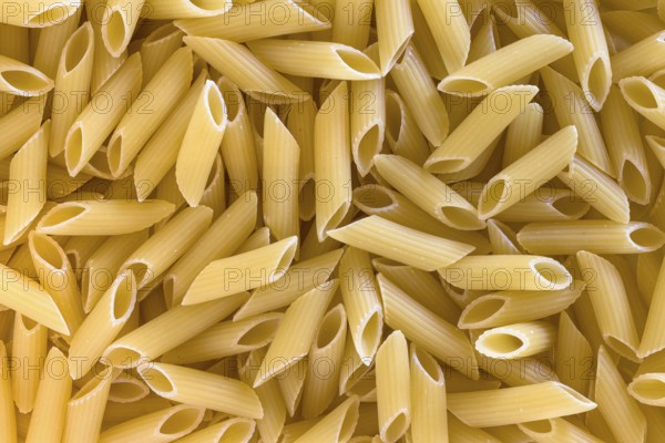 Extreme close up of uncooked italian penne pasta background