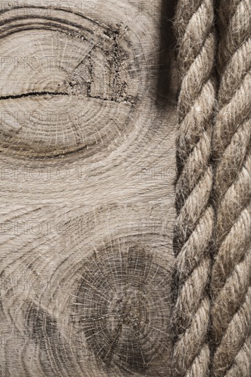 Vintage spirally twisted flax ropes on wooden board top view