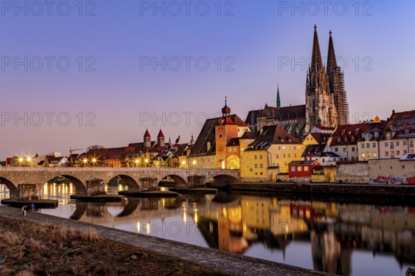 View of Regensburg Cathedral and the stone bridge over the Danube in winter in Regensburg, Bavaria, Germany