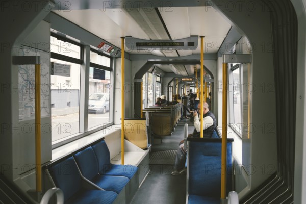 High-speed tram on the city street. Modern Tram In Dusseldorf, Germany October 20, 2018. Tram inside view, passenger compartment with passengers during a ride in Germany