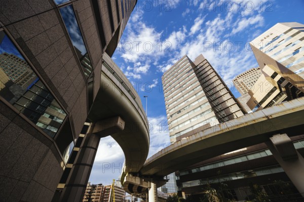OSAKA, JAPAN - SEPTEMBER 25 2024: The famous 'highway thru a building'. The off ramp for the Umeda Exit of the Ikeda Route of the Hanshin Expressway going thru the Gate Tower Building in Downtown Osaka, Japan