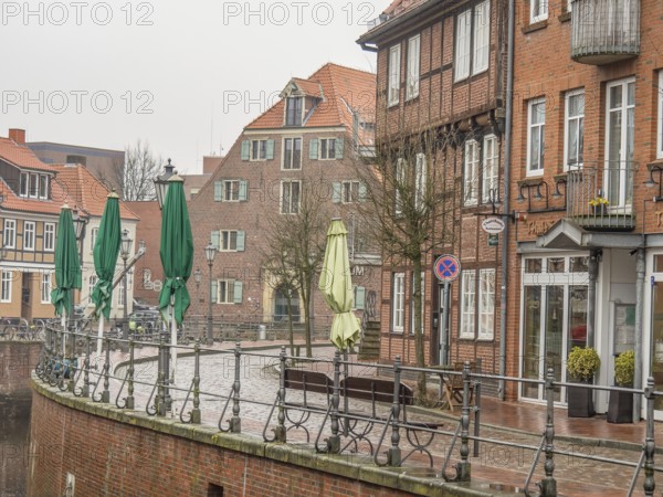 Street scene with brick buildings and closed green sunshades in a quiet atmosphere, stade, germany