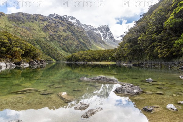 Tranquil mountain lake Mackenzie at the famous Routeburn Track, Fiordland National Park, South Island of New Zealand