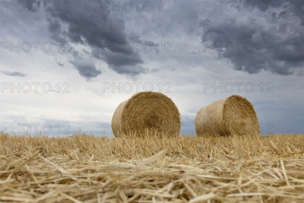 Straw bales on farmland Storm clouds