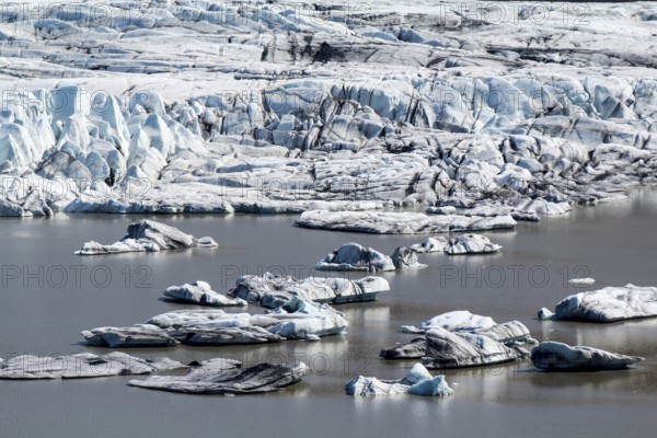 Close-up of Skaftafell glacial tongue, small icebergs in the lake, Iceland