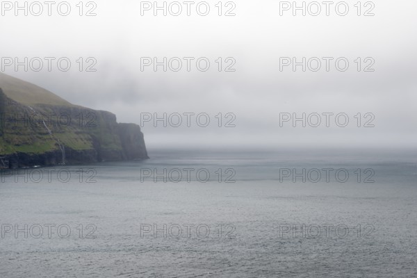 Rocky landscape on the Faroe Islands with cliff and ocean, Eidi, Faroe Islands, Denmark