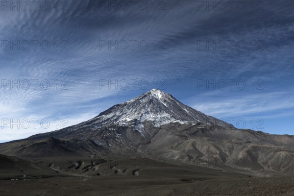 Scenery mountain landscape: view on cone of active Koryak Volcano (Koryaksky Volcano), beautiful clouds and blue sky. Koryaksky-Avachinsky Group of Volcanoes, Kamchatka Peninsula, Russian Far East, Eurasia