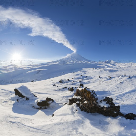 Best mountain travel destination for active vacation in winter season, snowy volcanic landscape and beauty magical eruption active volcano. Klyuchevskoy Volcano, Kamchatka Peninsula, Russian Far East