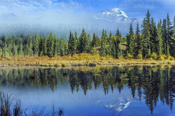 Wonderful landscape. The blue water of the Patricia Lake reflects the snowy peak of the Pyramid Mountain. The concept of active, ecological and photo tourism