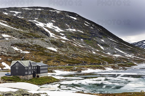 Semi-frozen lake Djupvatnet in the mountains of Northern Norway. Summer trip to Norway. Cold July in Northern Europe. Frozen lakes and waterfalls