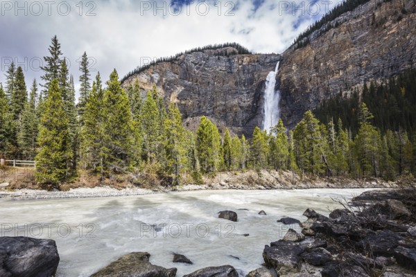 Colossal Takakkaw waterfall formed by melting glacier Daly. Autumn day in Yoho National Park in the Rocky Mountains of Canada