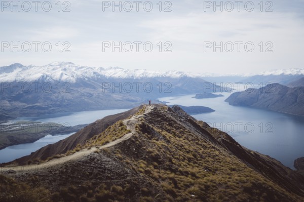 Mountain peak with a path looking down onto a frozen lake, Roys Peak, Wanaka, New Zealand