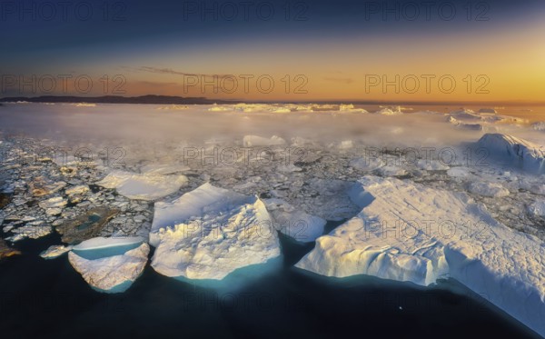 Floating glaciers in the rays of the setting sun during a polar night