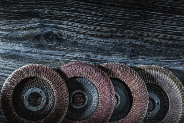 Rotary sanding discs on wooden board