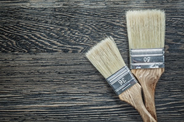 Paintbrushes on wooden board top view