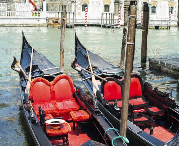 Ancient gondolas boat in Venice. Gondola red color interior