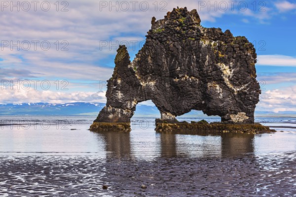 The picturesque cliff in Iceland as huge prehistoric monster. Remains of an ancient extinct volcano Hvitserkur on the sea shelf