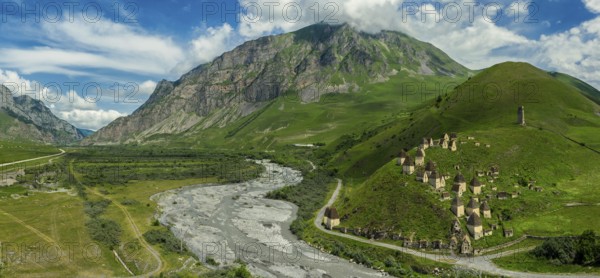 Aerial panorama of Dead Town Dargavs In North Ossetia. The ancient cemetery of the Alans. Many small stone mausoleums, standing on the side of a mountain