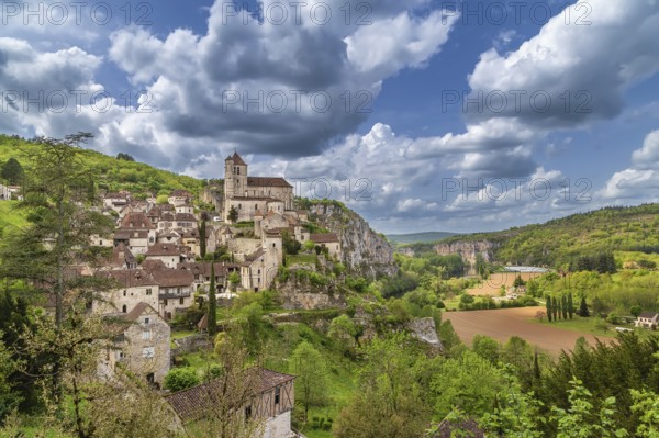 View of Saint-Cirq-Lapopie village with catholic church, France