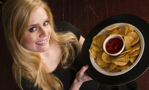 Vibrant service professional brings the servings