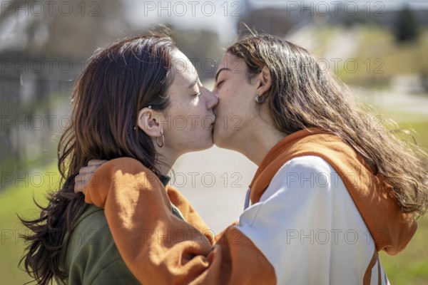 Lesbian couple kissing in a park