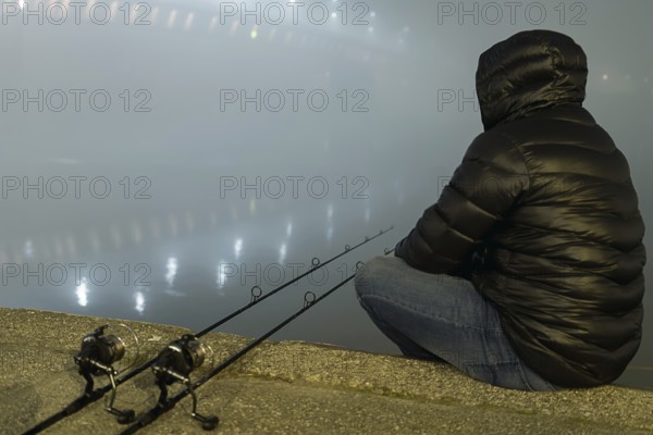Night Fishing Urban Edition. Fisherman in Foggy night. Night Fishing, Carp Rods, Night reflection. City lights