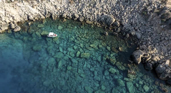 Drone aerial seascape with luxury yacht moored on the coast. Blue water Summer vacations in the sea. Cape Greko Cyprus