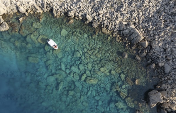 Drone aerial photograph of Cape Greko peninsula. Boat in the ocean. Turquoise ocean water
